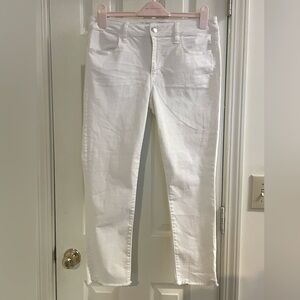 Never worn white cropped skinny jeans with ruffled hem.